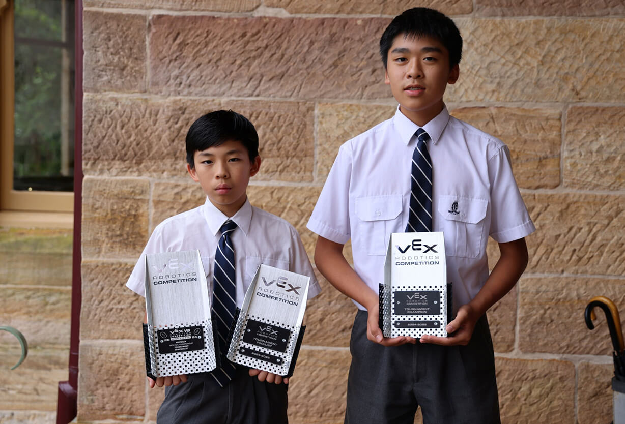 Students holding Robots